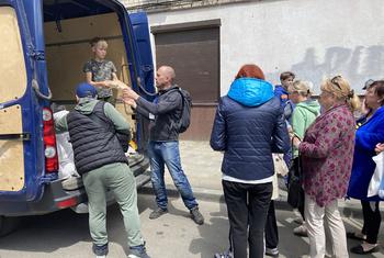 Food is distributed to people in Kharkiv during the conflict in Ukraine.