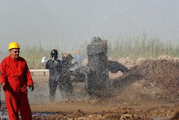  Oil engineers spray water to cool off oil wells in northern Iraq. (file)