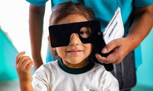 秘鲁首都利马，一个小女孩正在校内接受视力检查。