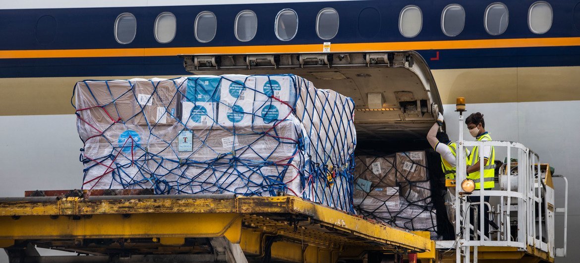 Airport staff unload cargo of PPE supplied by UNICEF at Yangon International Airport, Myanmar.