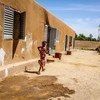 A girl runs outside a small community school in Korioume, Mali, where children lack basic equipment, including notepads and pens. Parts of the school have been attacked and in 2013 the village was a Jihadist stronghold. 