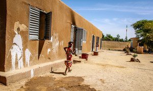 A girl runs outside a small community school in Korioume, Mali, where children lack basic equipment, including notepads and pens. Parts of the school have been attacked and in 2013 the village was a Jihadist stronghold. 