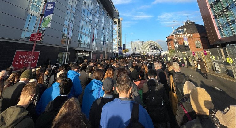 Long lines of participants wait to pass security and enter the Blue Zone at the Scottish Event Campus, at the COP26 Climate Conference in Glasgow, Scotland.