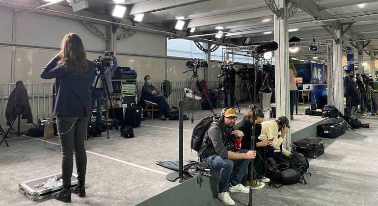 Journalists take a rest after a busy day at the COP26 Climate Conference in Glasgow, Scotland.