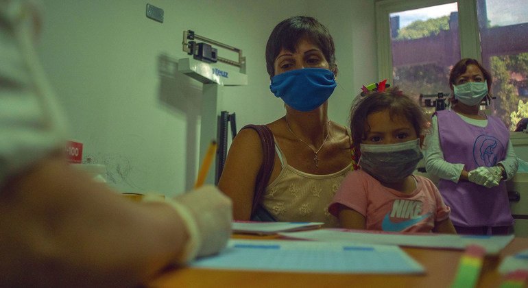 Una madre lleva a su hija a una cita médica en un centro de salud en Caracas, Venezuela.