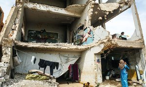 Sixteen families live in a damaged school in Binish, a city in northwest Syria.
