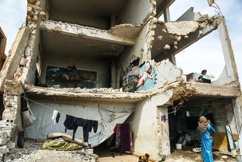 Sixteen families live in a damaged school in Binish, a city in northwest Syria.