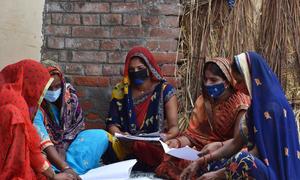 Farmer Producer Group members tallying the procurement figures at Dhanapur village, Uttar Pradesh, India.