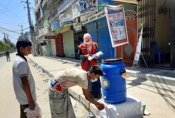 Bangladesh Red Crescent Society's staff and volunteers promote hand washing, spray disinfectant and provide emergency food, to fight against COVID-19.