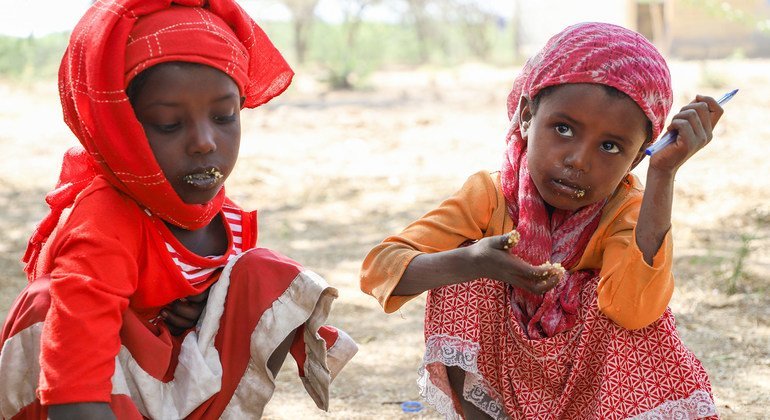 فتاتان صغيرتان تنتظران الطعام الذي يوزعه برنامج الأغذية العالمي في إثيوبيا.
