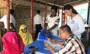 A UNHCR officer helps register Rohingya refugees in Kutupalong Refugee Camp in Cox’s Bazar, Bangladesh. (24 July 2019)