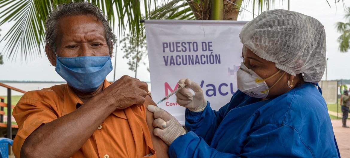 A member of the indigenous community in Colombia receives a COVID-19 vaccination