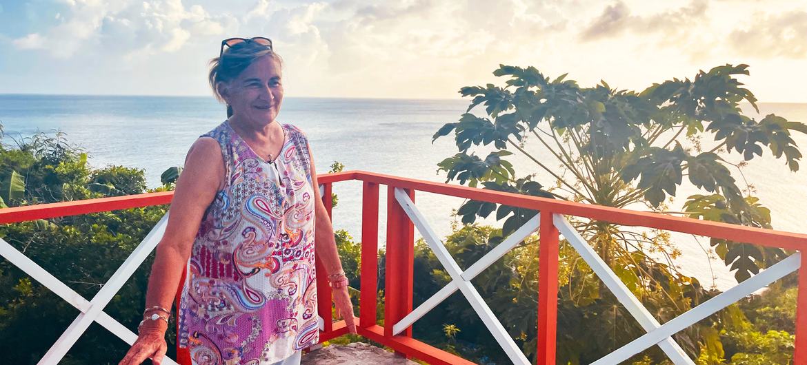 Marcela Cano stands on the re-built deck of her house in Providencia.