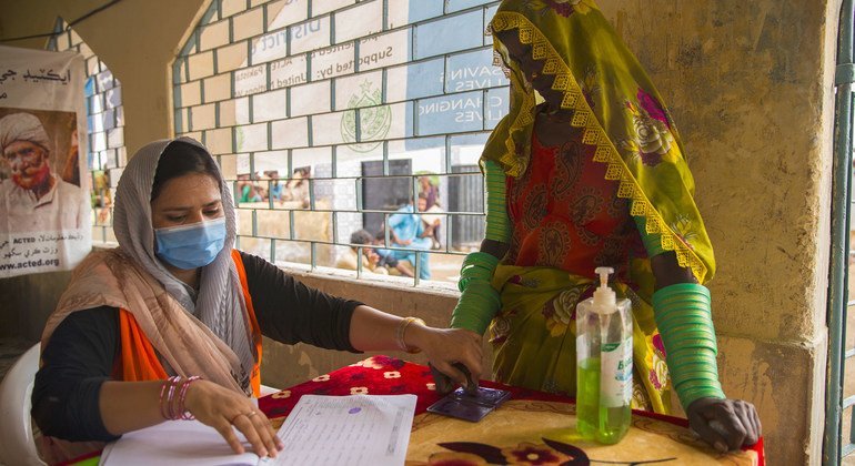 A woman is registered for a World Food Programme (WFP) ration package at a food distribution point for flood affected families in Umerkot, Pakistan.
