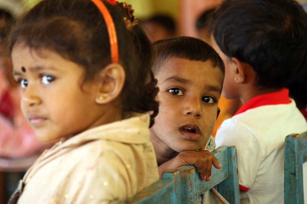 Young children wait in Sri Lanka for Mobile Health Clinic at  