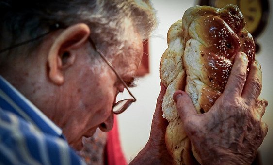 Freddy Glatt blesses bread at the beginning of Shabbat, the holy day of the Jewish religion.