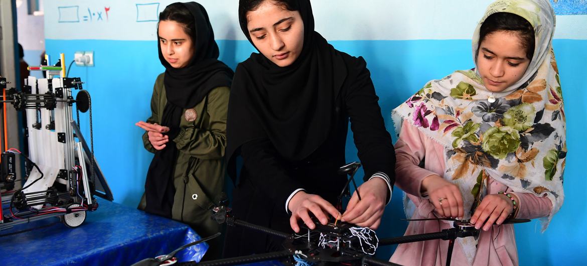 Young girls work on a robotics project in Afghanistan.