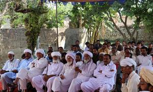 Community members  in Punjab, Pakistan, participate in a meeting to discuss the proper use of natural resources.