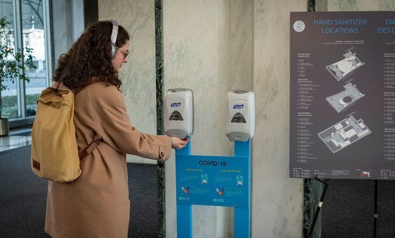 Funcionária da ONU higieniza as mãos ao entrar na sede da organização em Nova York.