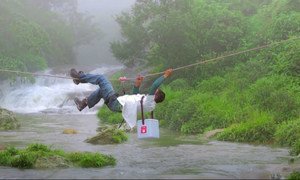 A vaccine carrier is carefully transported across a river in India. It’s a delicate process - the vaccines need to be kept cold, even in tropical parts of the world. 