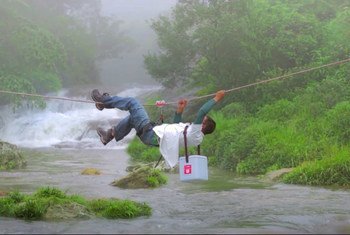 A vaccine carrier is carefully transported across a river in India. It’s a delicate process - the vaccines need to be kept cold, even in tropical parts of the world. 