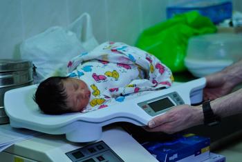 A newborn baby is weighed on a scale at a hospital in Ukraine on 7 March 2022.