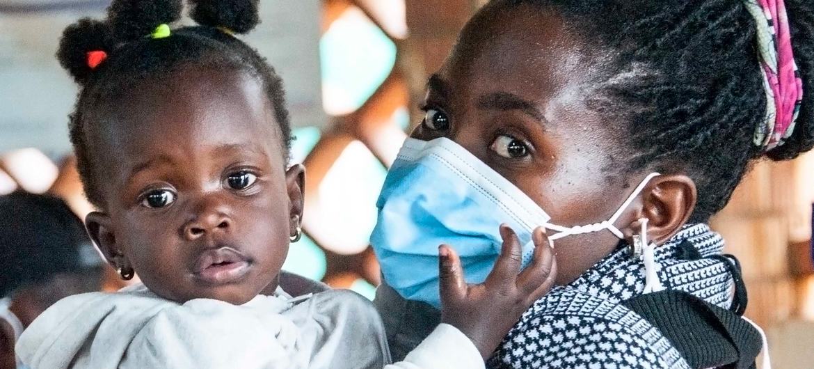 Las vacunas COVID-19 se administran en un hospital de Masaka, Uganda, donde espera esta madre con mascarilla y su bebé. 