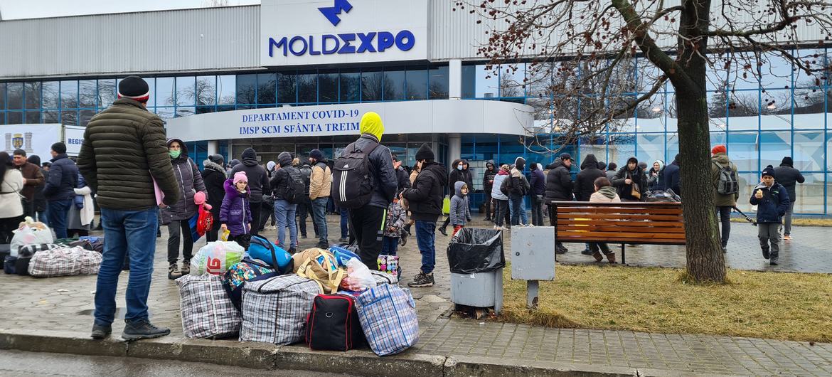 Newcomers from Ukraine wait outside an exhibition center, which has turned into a refugee centre, in the Moldovan capital Chisinau.