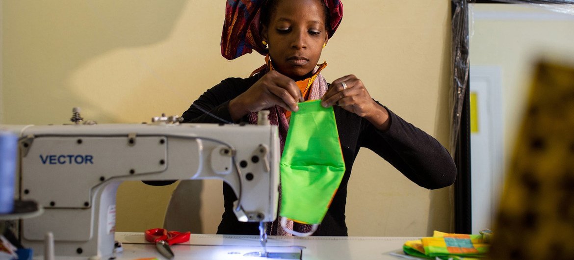 A woman sews face masks to sell during the COVID-19 crisis in South Africa.