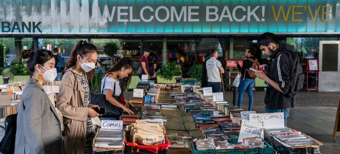 Members of the public browse a book stall in London after COVID-19 restrictions were lifted.