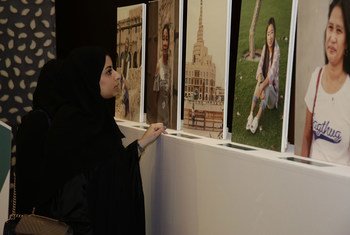 A woman views an exhibition of portraits of domestic workers on their day off on International Domestic Workers Day in Qatar.