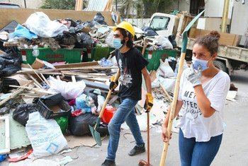 志愿者正在清理爆炸后的废墟。