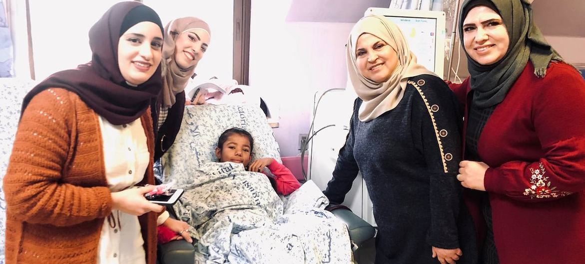 Shahd, 11, with staff from the School of Determination at Augusta Victoria Hospital, Palestine.