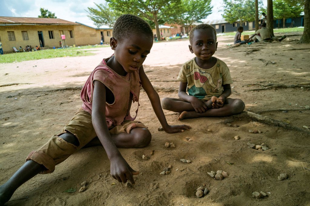 Des enfants déplacés par la violence jouent dans une cour d'école en République démocratique du Congo.