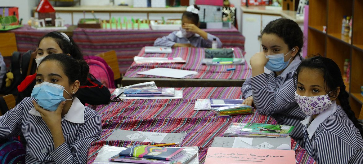 Students wear face masks at a school in the Far'a refugee camp in the West Bank.