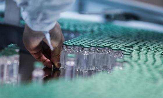 An employee works on a COVID-19 vaccine production line in India