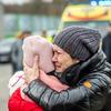 A woman holds her child as she arrives in Berdyszcze in Poland, after crossing the border from Ukraine.