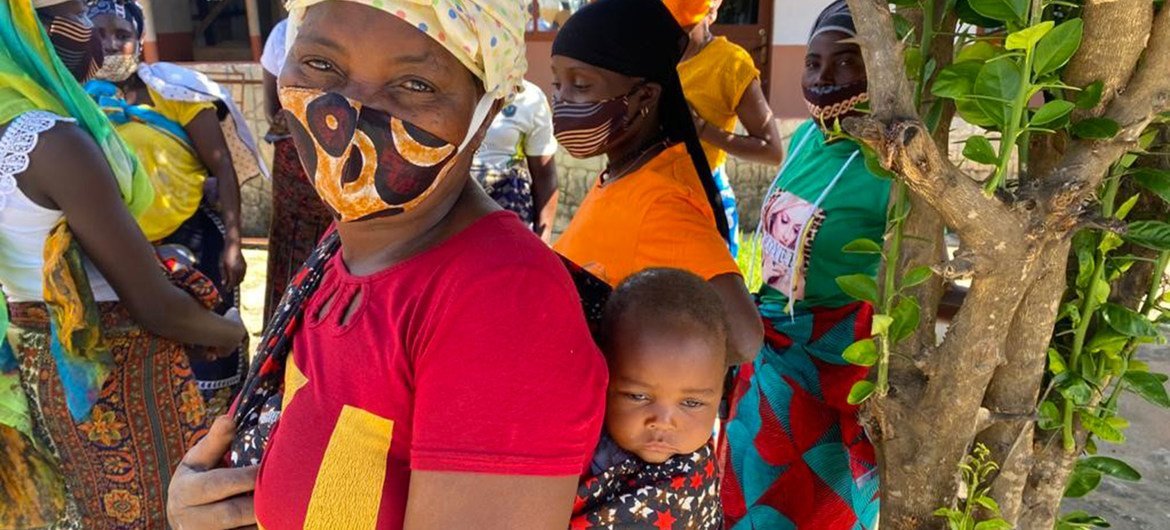 A woman and her baby who fled their home in northern Mozambique in November 2020 are now living in a camp for displaced people.