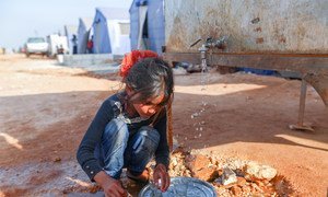 On 23 April 2020, a child washes dishes in the Maarat Misrin camp north of Idlib, Syrian Arab Republic.