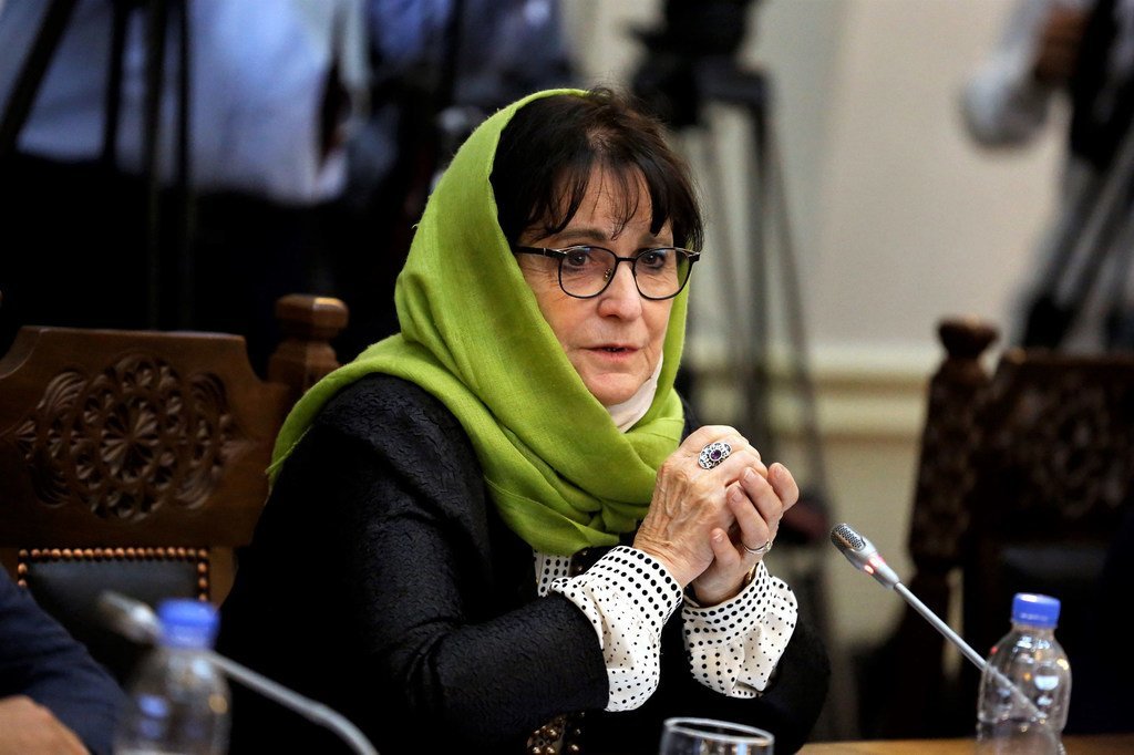 UN envoy Deborah Lyons speaking at a formal meeting, wearing a green headscarf and glasses.