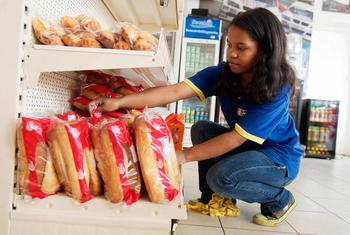A young female employee works at a gas station in Antsirabe. Madagascar.