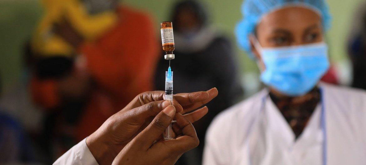 A health worker prepares a vaccine injection for administration. (file photo)