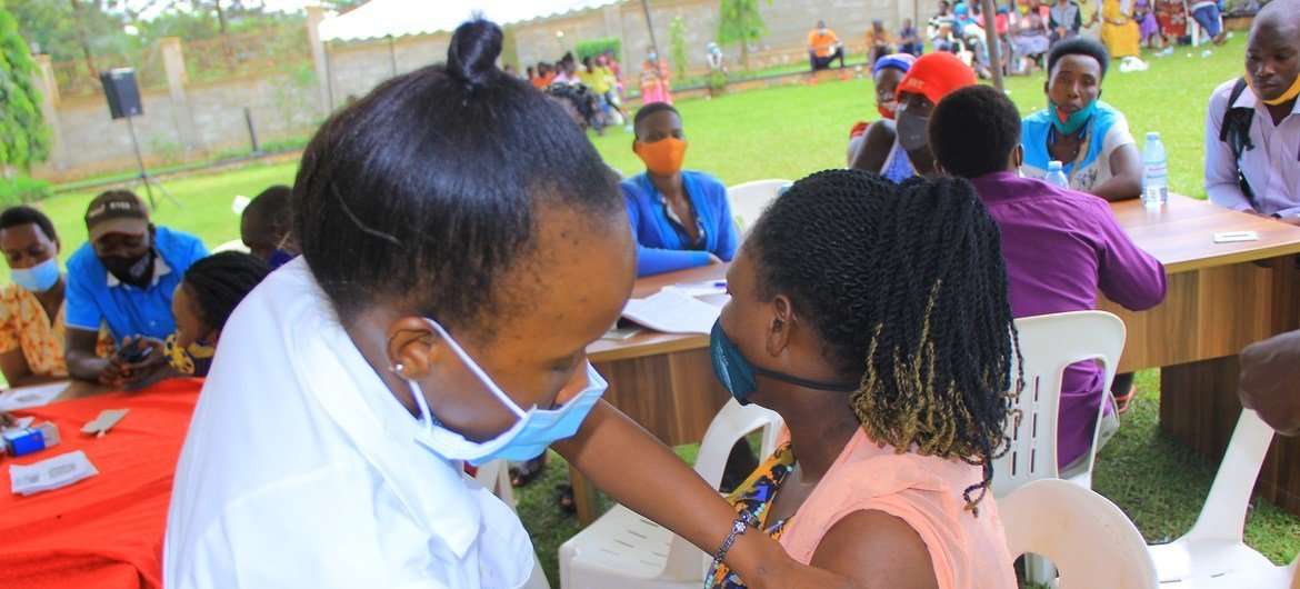 A woman receives her first COVID-19 vaccine in Hoima, Uganda.