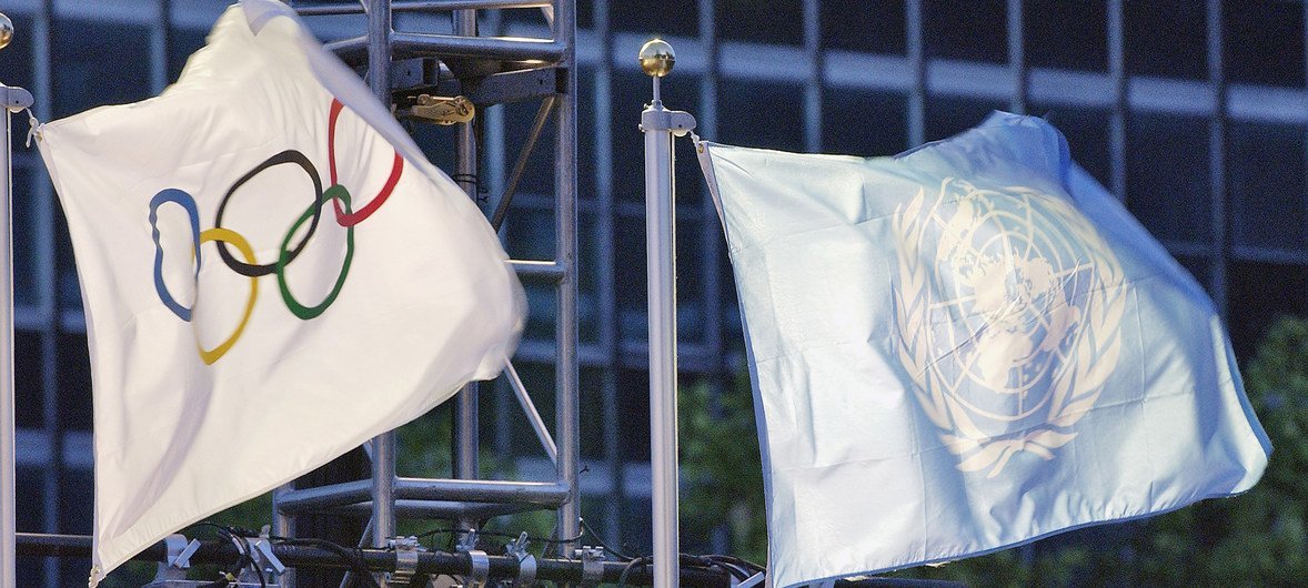 The UN and the Olympic flags are raised at headquarters shortly before the torch ceremony.