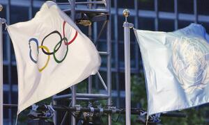 The UN and the Olympic flags are raised at headquarters shortly before the torch ceremony.