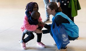A UNHCR staffer welcomes resettled refugees originally from Syria and South Sudan at Lisbon airport in Portugal. (file)