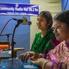 In Teknaf, Bangladesh, presenter Joya Pul Happy (left) and her producer Shanta Pul at the community radio, work on an upcoming show. (August 2018)