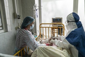 A mother and a doctor tend a girl with COVID-19 at an intensive care ward, in Chernivtsi, Ukraine.