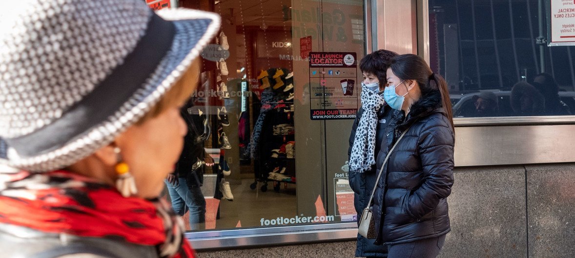 New York City residents wear face masks as a precaution against the coronavirus, COVID-2019