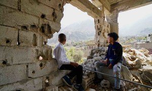 Two children, who recently returned home after they and their family fled fighting in 2017, look out over the Al Gamalia neighborhood of Taiz City.